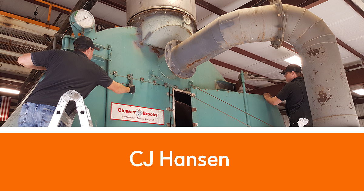 Two men working on a large industrial unit | CJ Hansen