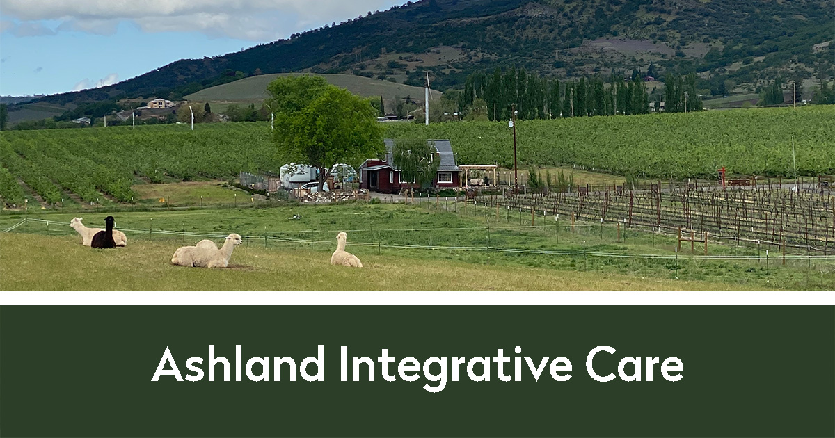 Alpacas on a farm with a hill in the background | Ashland Integrative Care